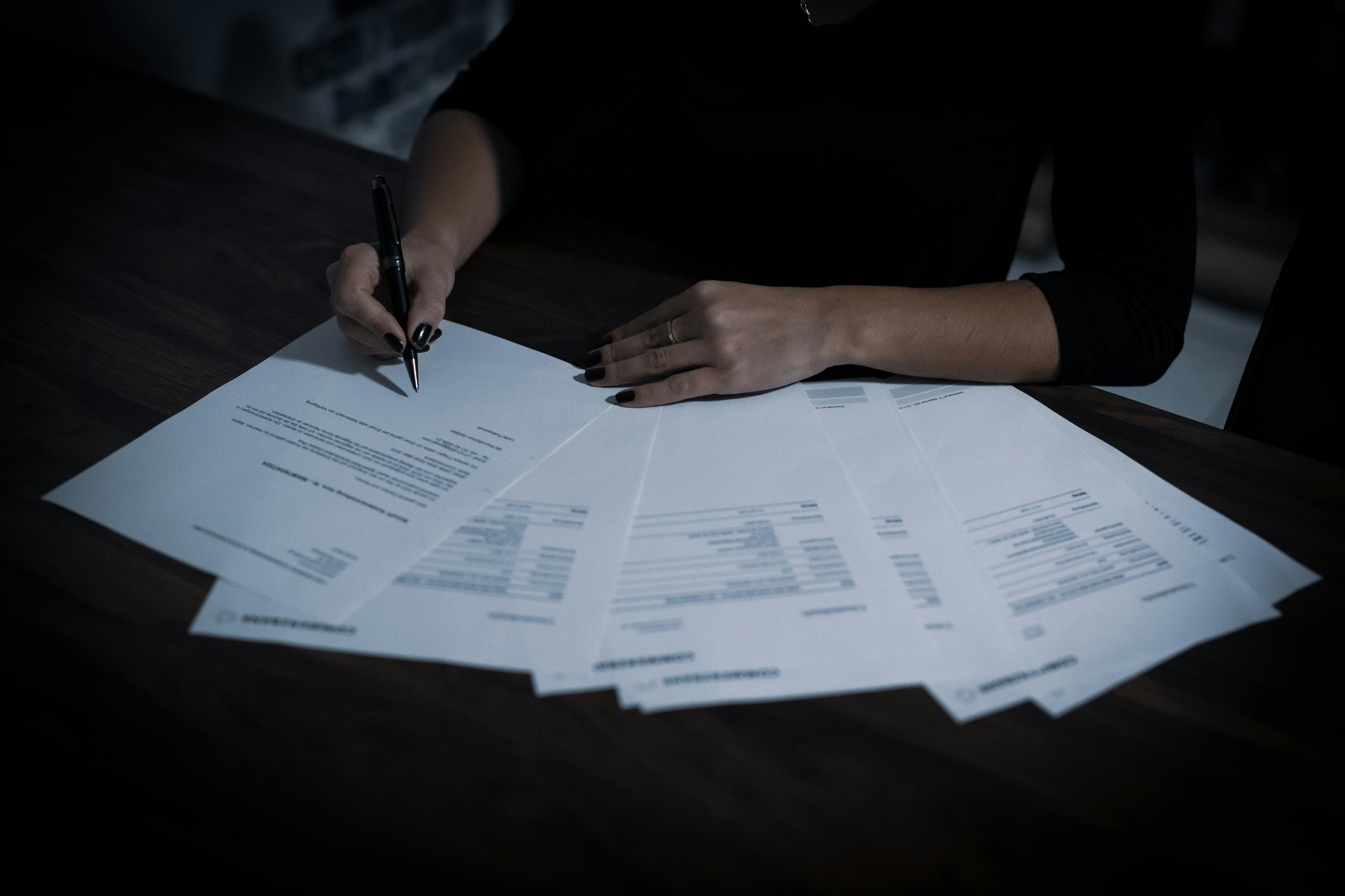 Advogada organizando documentos e planilhas para estruturar uma decisão tributária